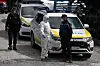 Un policier s'entretient avec un membre de l'Unité d'urgence militaire de l'armée espagnole portant une combinaison de protection à l'extérieur du centre commercial Palacio de Hielo.